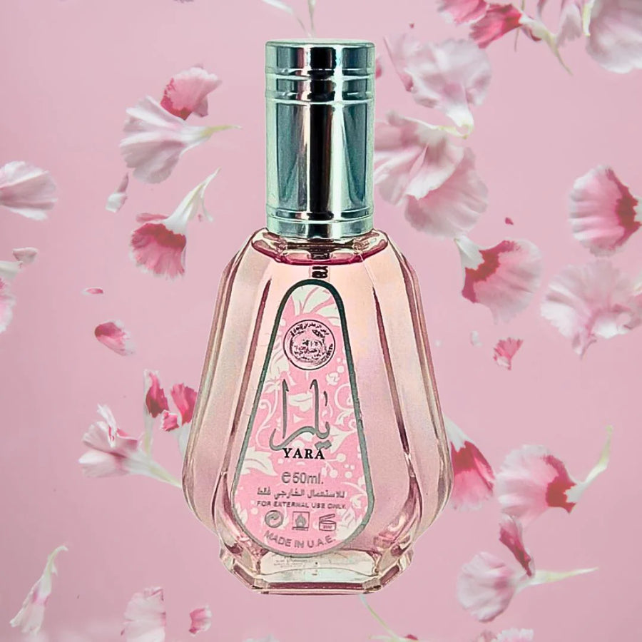 Perfume bottle with floral design on a pink background